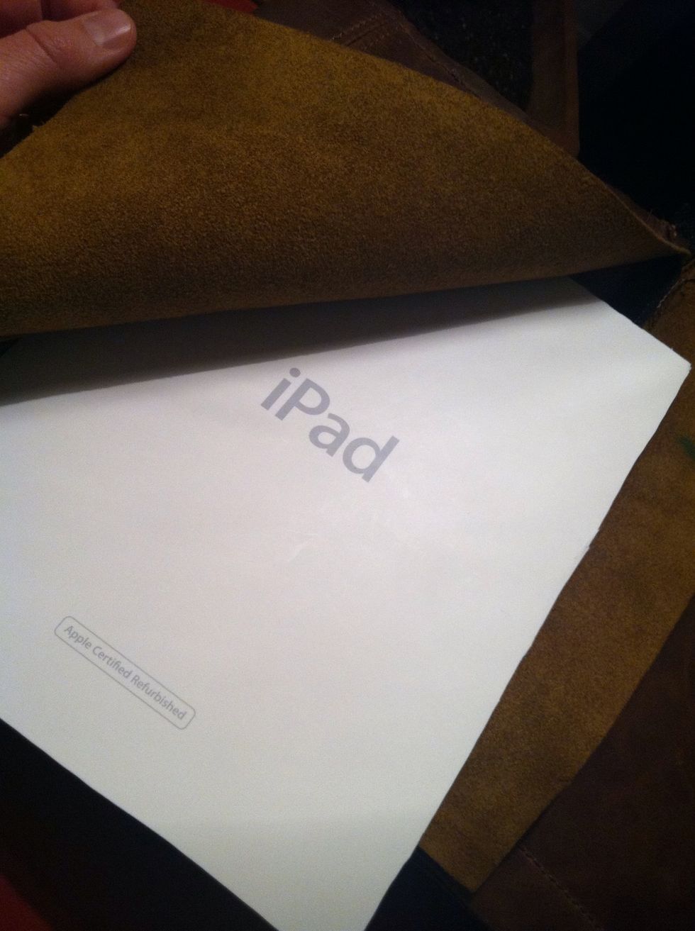 Now we need to make the front cover sturdy. So I cut out the top if the iPad box and inserted it into the front cover. It's quite firm and on the back side it has some cloth for padding.