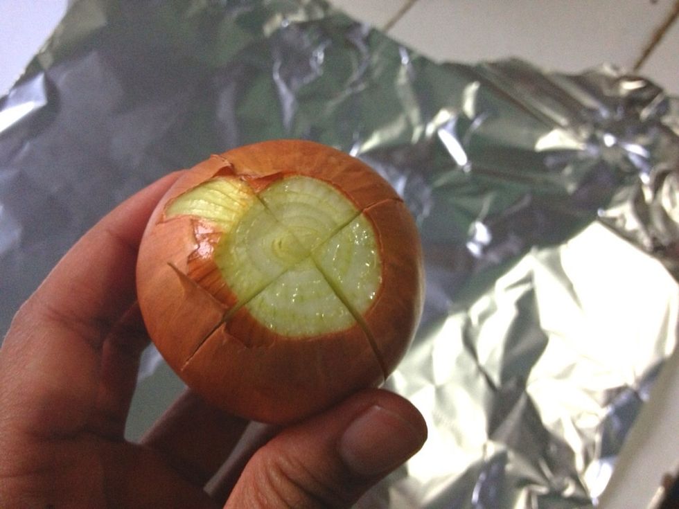 Now we prepare the roasted onions. Wash and pat dry some small onions. Peel the outer skin only. Make an incision in the middle, to allow the herbs and olive oil infused more