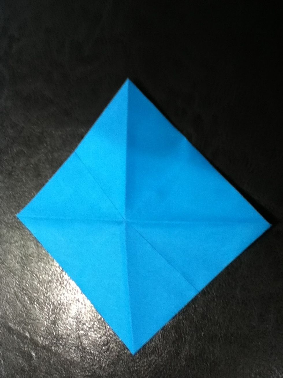 Now we're going to make a basic square base. If you know this, skips to step 9. Flip your paper over.
