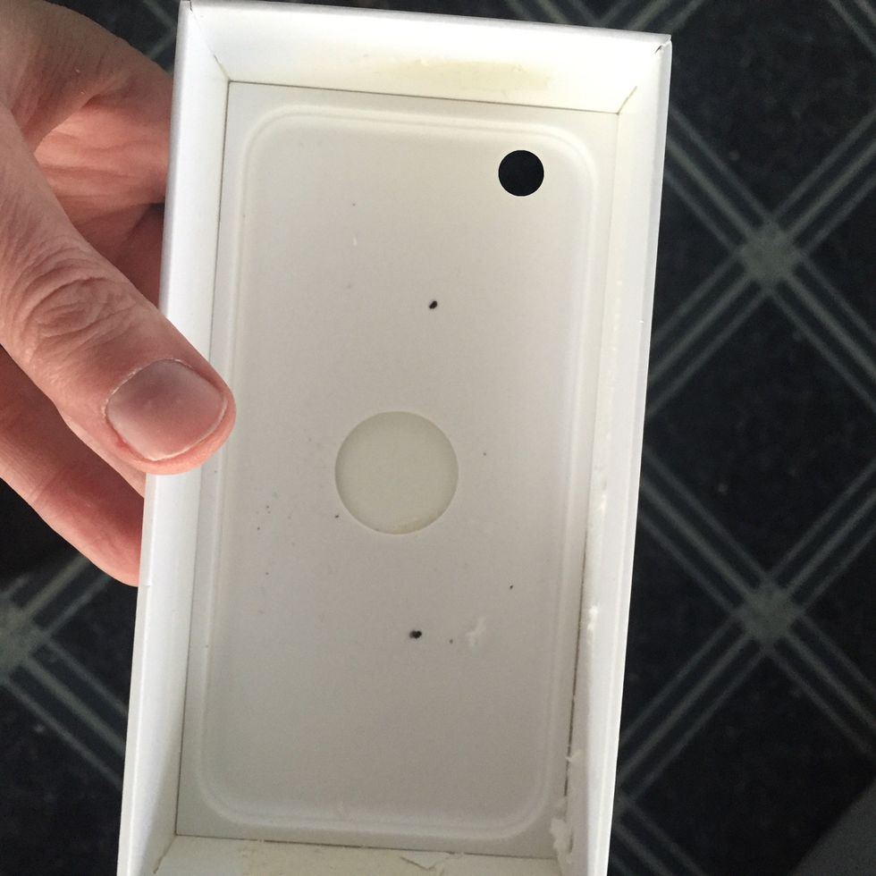 Now we're going to reassemble the bottom of the box in a specific way. So put the tray back into the box.