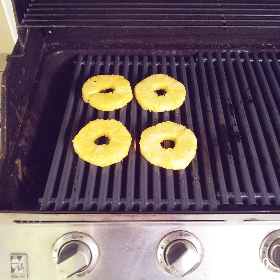 Now we're ready for the pineapple! Fire up the grill and let the pineapple cook for about 3-4 minutes on each side. (Don't forget to use cooking spray for the grill)