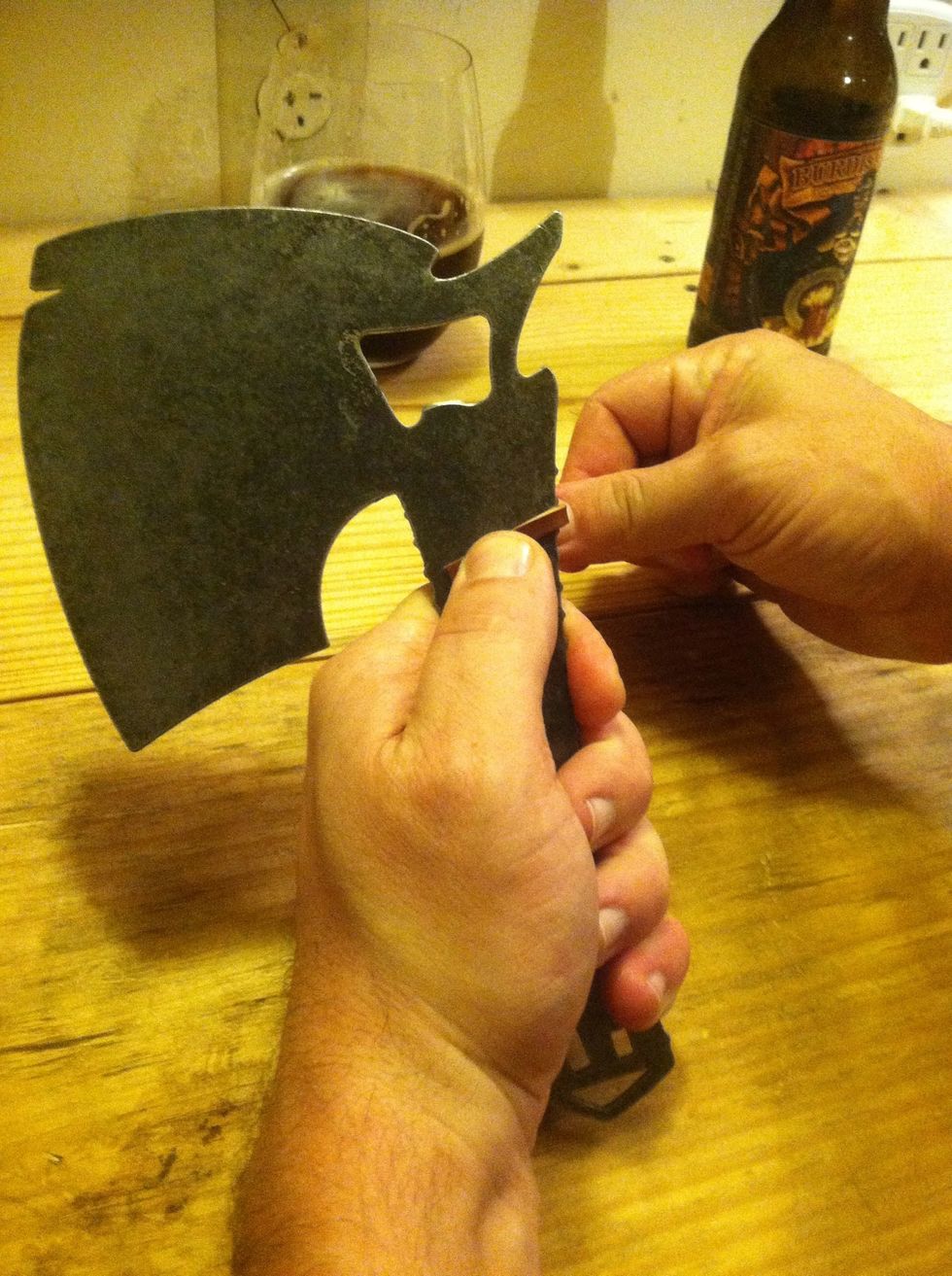 Now we're ready to get to it! With your blade facing left, the end of the leather lace points to the third notch opening on the left while wrapping around the second opening on the right.