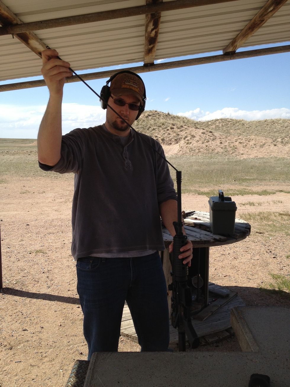 Now we take a rod (I use one that comes off my Mosin-Negant rifle) and gently guide it into the barrel. Gently tap downward until the casing comes out.