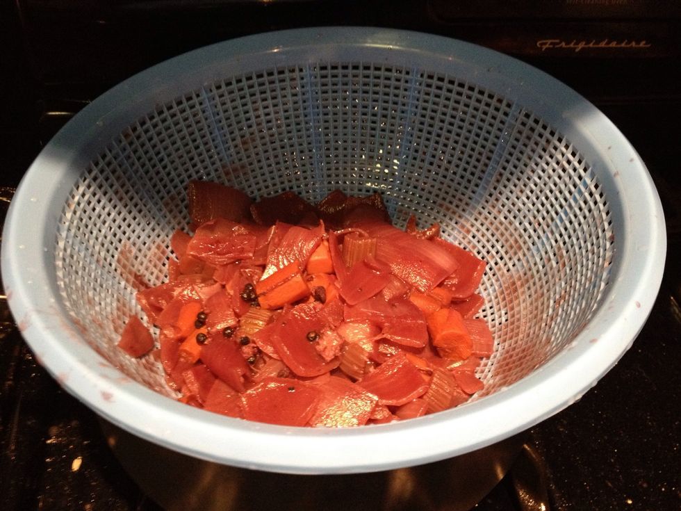 Now we will add the marinade to the sauce pan. Strain out the solids and add the sauce to the pan.
