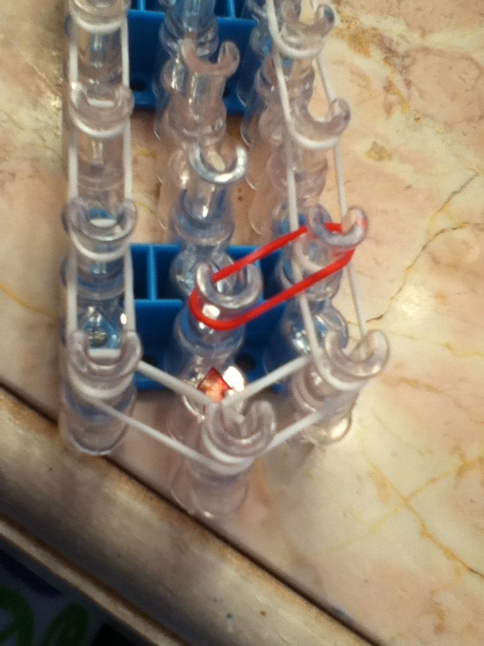 Now we will be making our first flower. Add any color band, just like shown. We will be working counter clock wise.