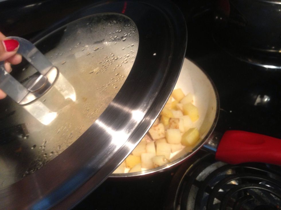 Now we will fry the potato cubes till it gets golden brown. Once you use the lid over the pan it gets cooked faster and saves electricity.. :) We should half cook them.