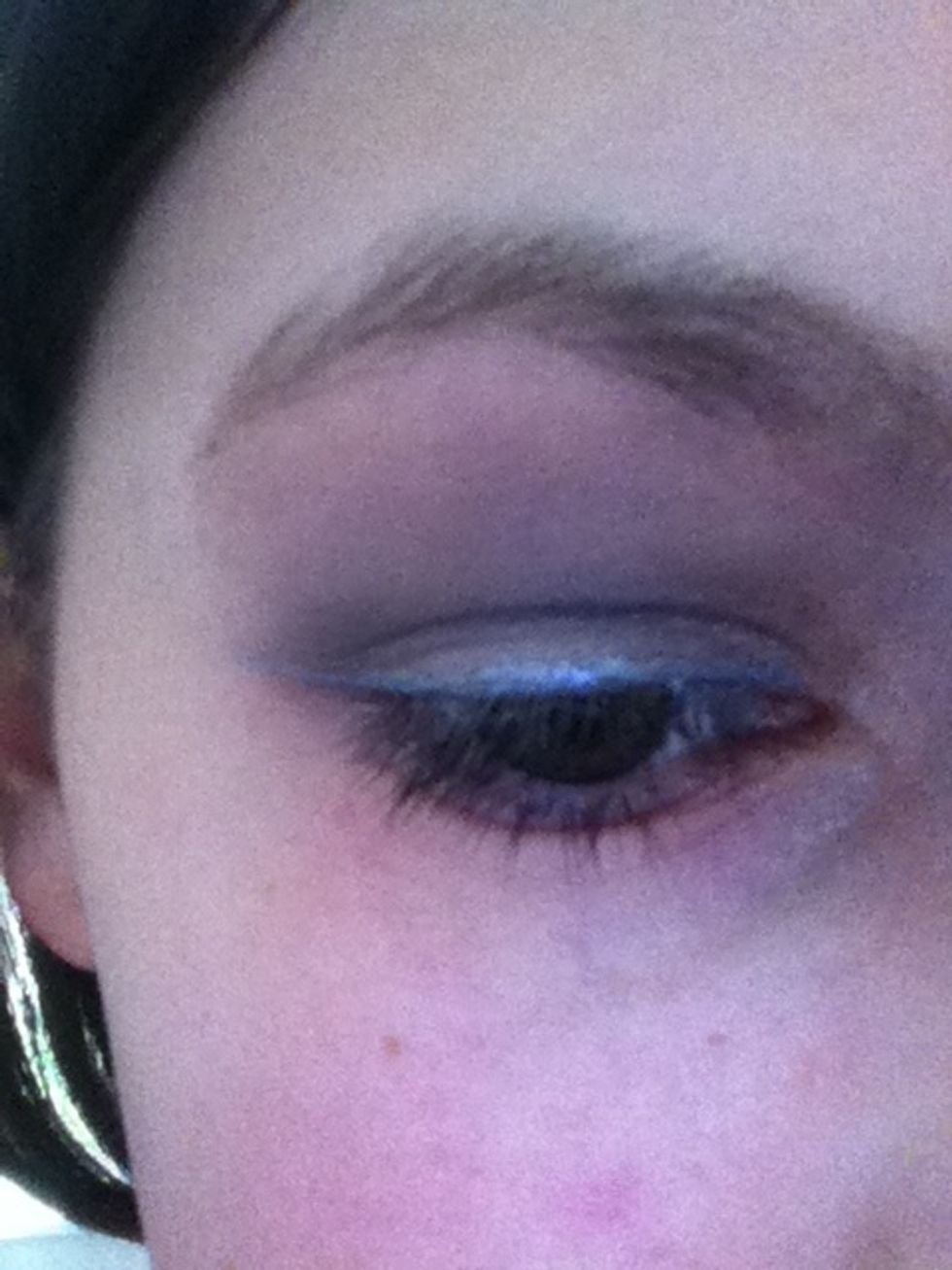Now with a liquid silver eyeliner, follow your upper lash line across.
