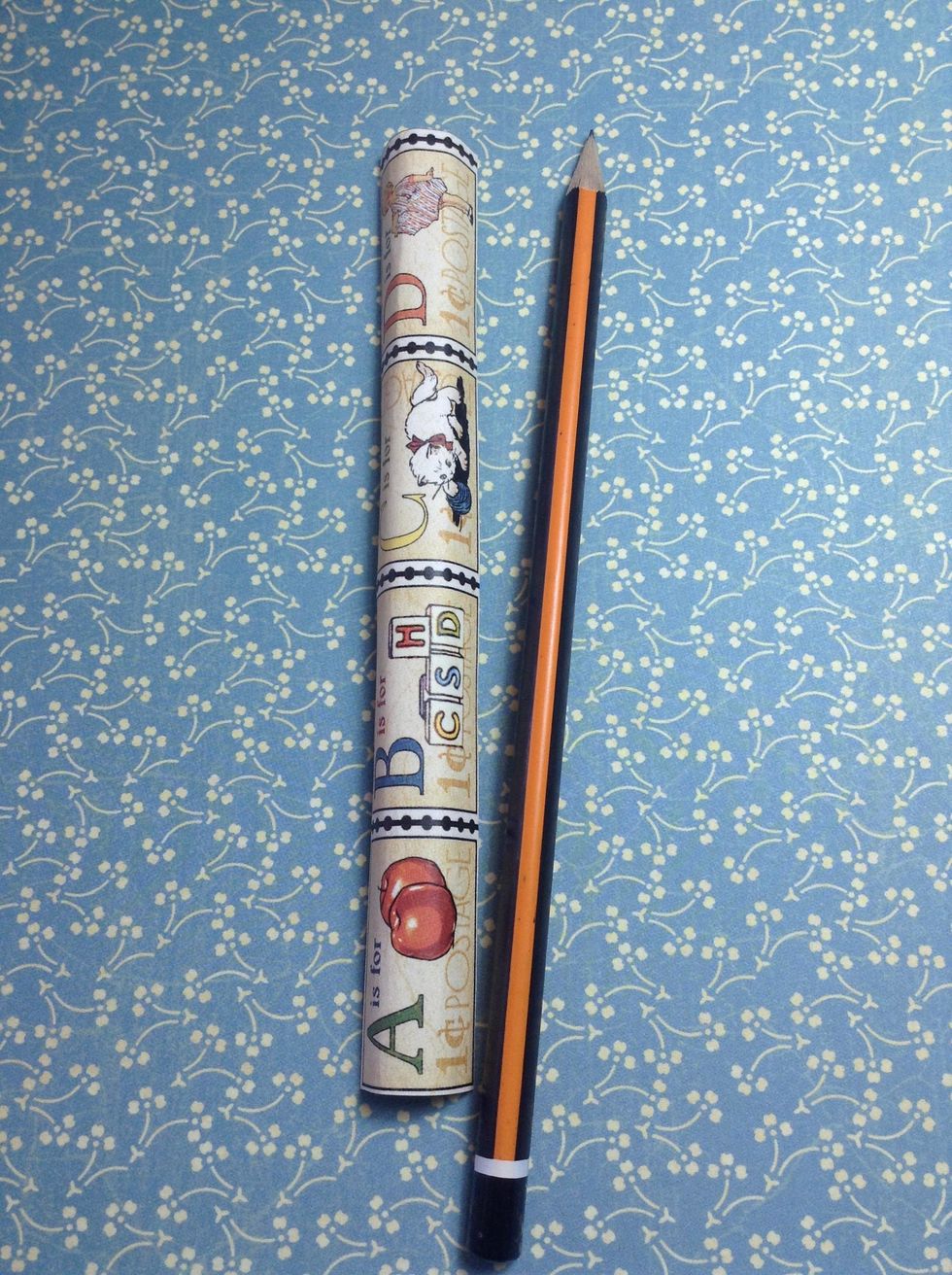 Now, with a pencil and a piece of paper, start rolling the piece around it..