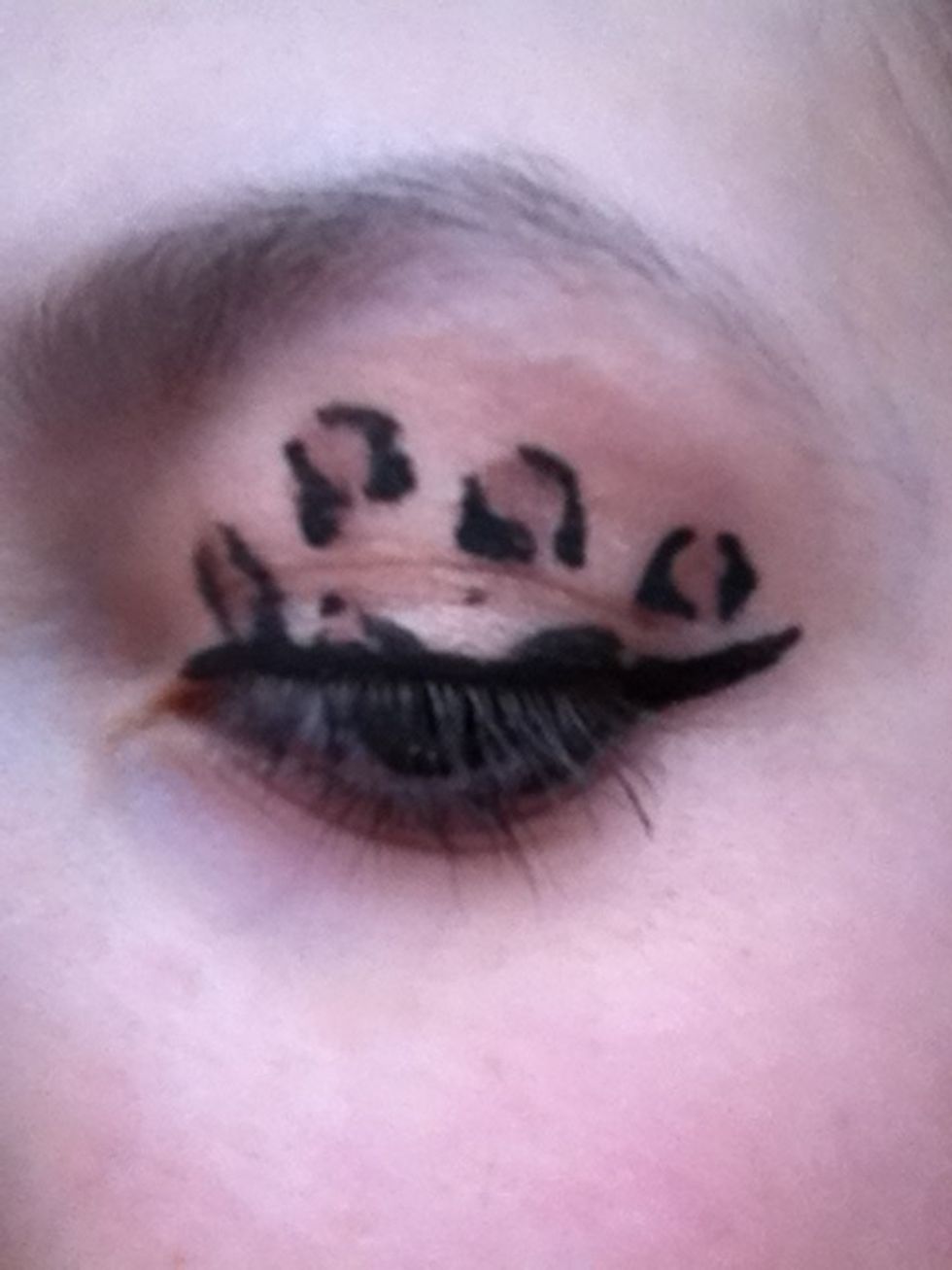 Now with the same black eyeliner, go along your top lash line and flick up the line at the end.