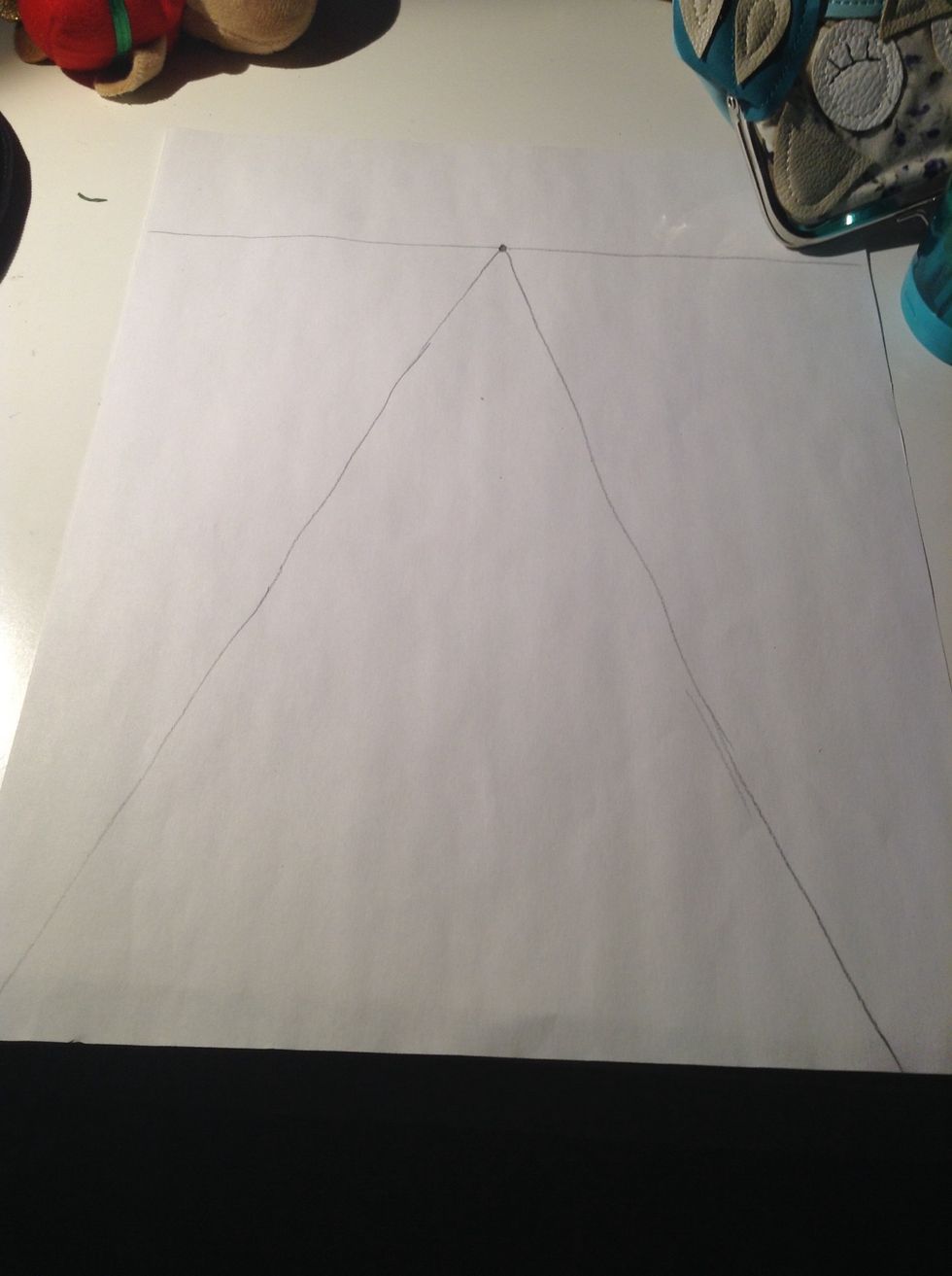 Now with your ruler do 2 straight lines from the dot going wider as you draw the lines closer to you if your dot isn't in the middle the lines might go on a slant but that is ok