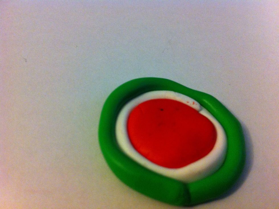 Now, wrap a green strip around the white one.