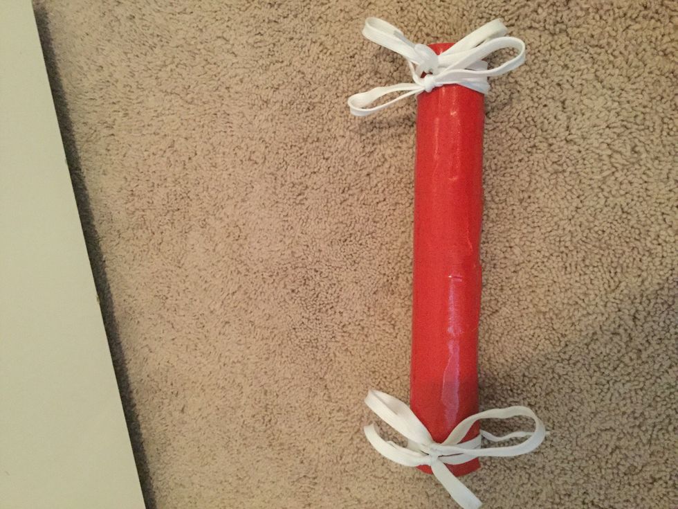 Now wrap the bigger roll with tape or cover with paint and with shoelace or Ribon make a bow so the bracelets won't fall off.