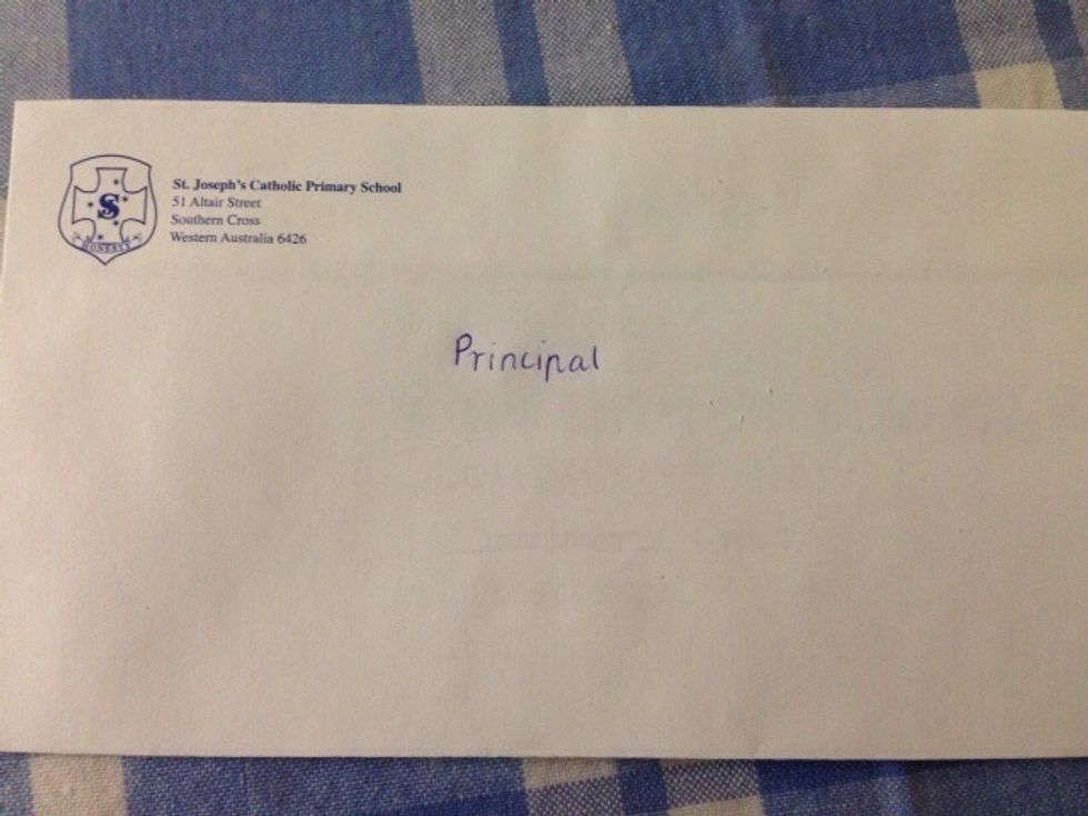 Now write down the name or title of the person to whom you will be writing towards the centre of the envelope. In my case i am writing to a Principal of a school.