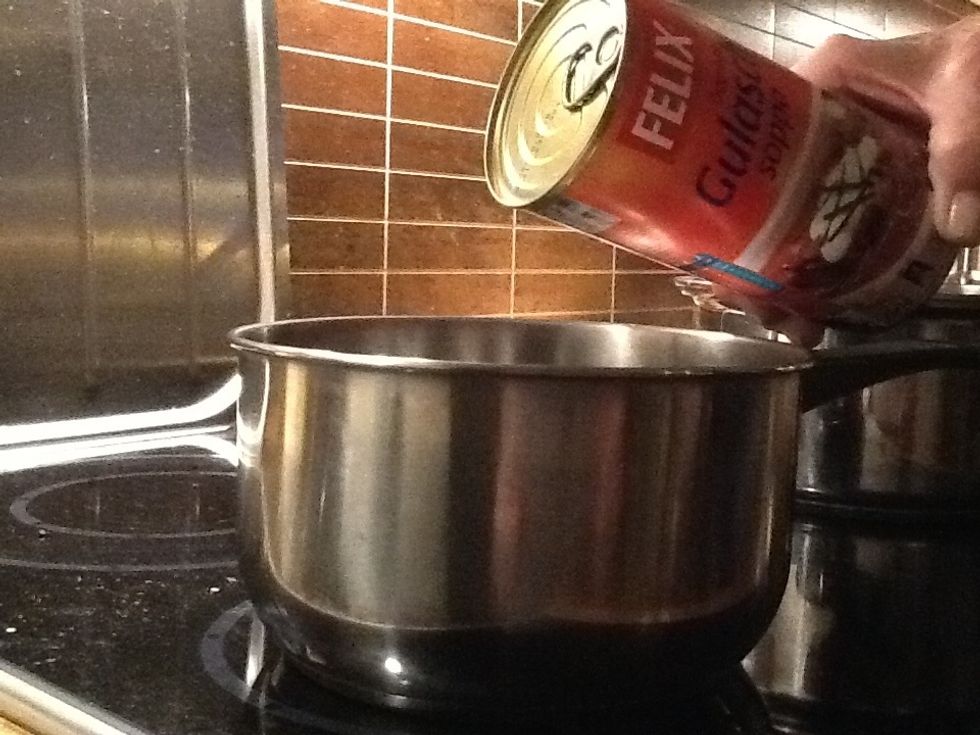 Now you are gonna pour the soup into a sauce pan. Then make sure that you mix the soup before you put on the stove and worm the soup.