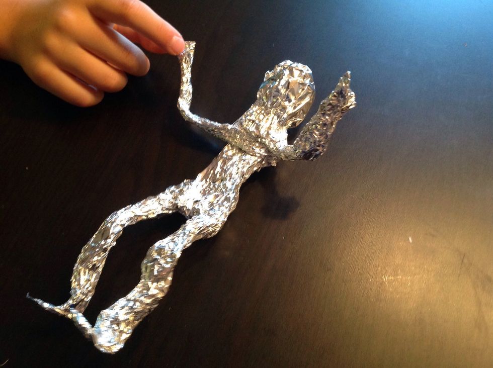Now you can add some more foil to the head and the rest of the body, as much as you like. And start bending the body into a position that expresses the feeling you want it to express, happiness, anger