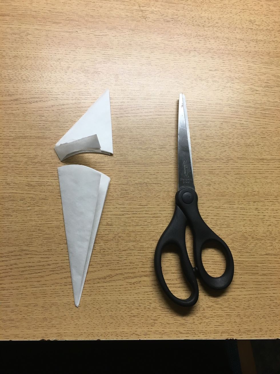 Now you can cut the top portion to make it circular. The more folds, the less rounded your cut needs to be. Alternatively, if you're going for a scalloped look, be sure to keep the cut curved.
