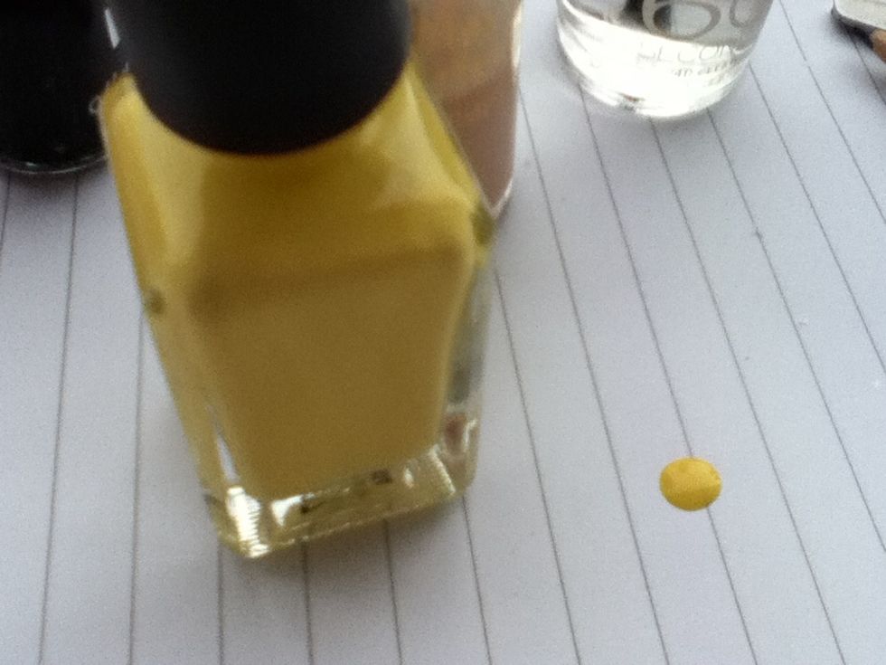 Now, you can do all of this with a nail art pen, but I don't have one, so I use a different method. Put a blob of yellow on paper.