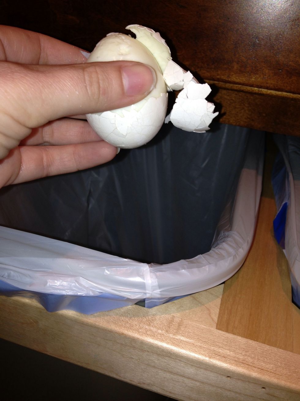 Now you can peel off the shell and throw it into the trash can. You may want to wash the egg to make sure got all the pieces.