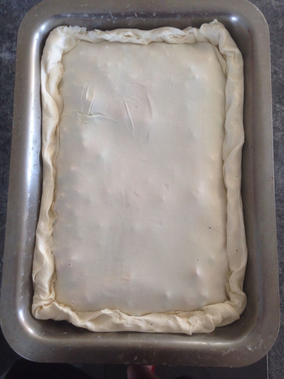 Now you can place the top pastry on. Wet your fingers and roll/pinch sides in towards middle and tuck down side