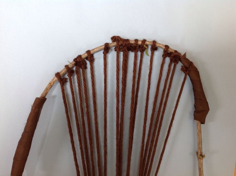 Now you can trim the long ends from the TOP of the loom. be careful not to cut your "warp" strings. That is what we call these vertical pieces of yarn into which you will weave.
