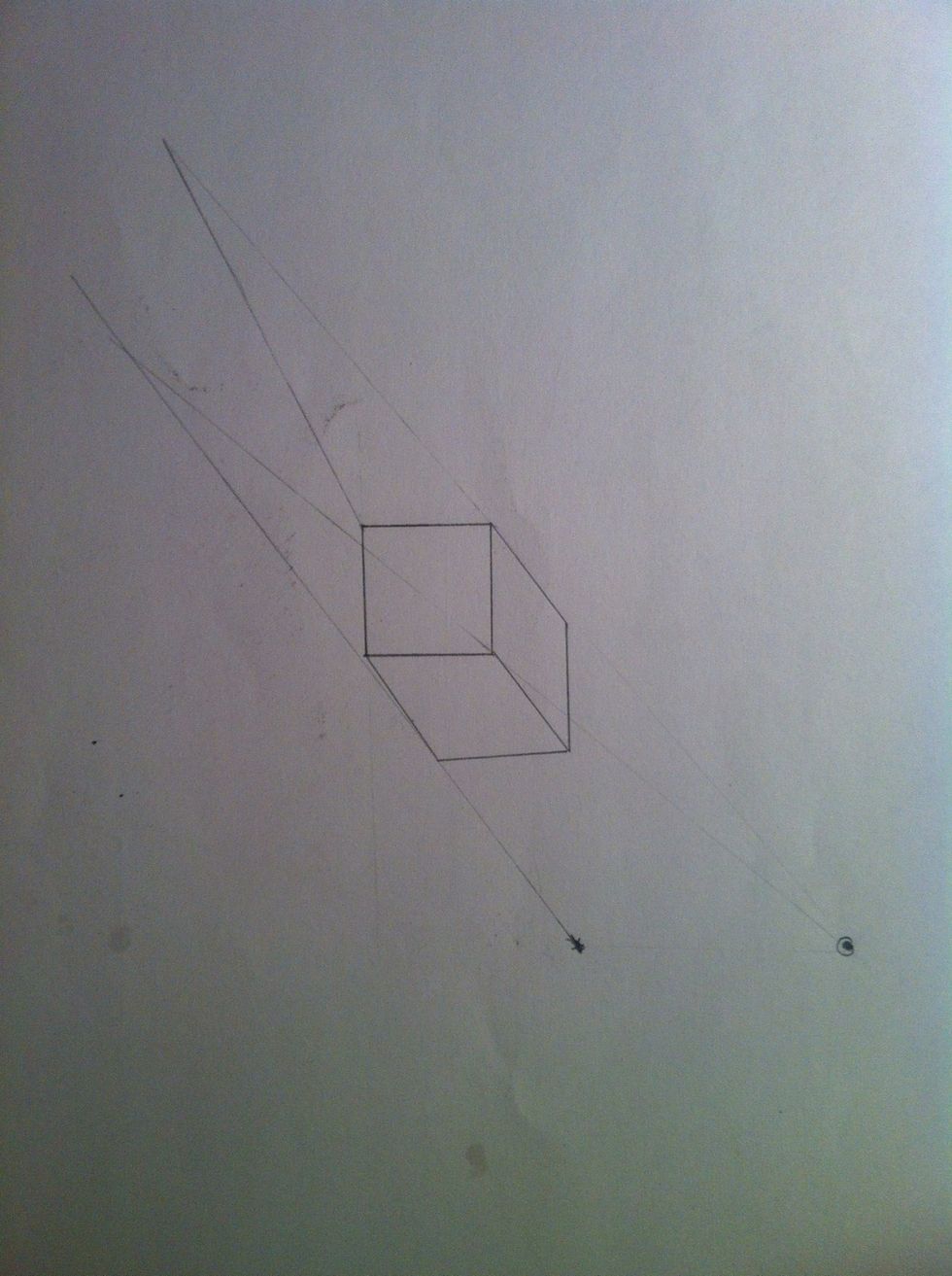 Now you draw two straight lines from the sun through each visible top corner of the block.
