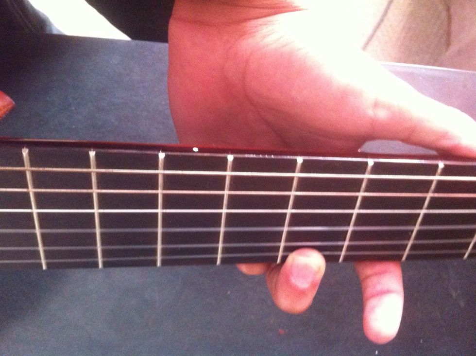 Now you go two threads left from 5th tread on bottom string..