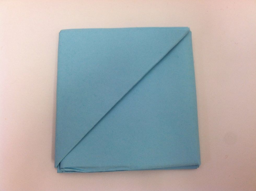 Now you have a square. The square has a diagonal line running down the center. This line divides the square into two triangles.