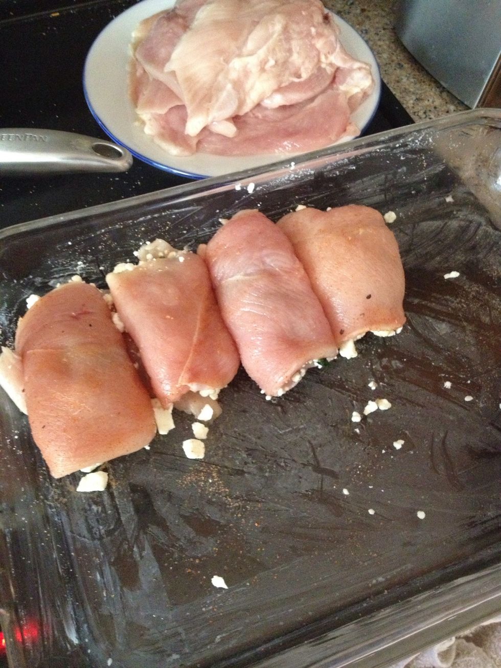 Now you have the space to lay out more chicken halves, season them on both sides, and add some spinach and feta again until all are done.