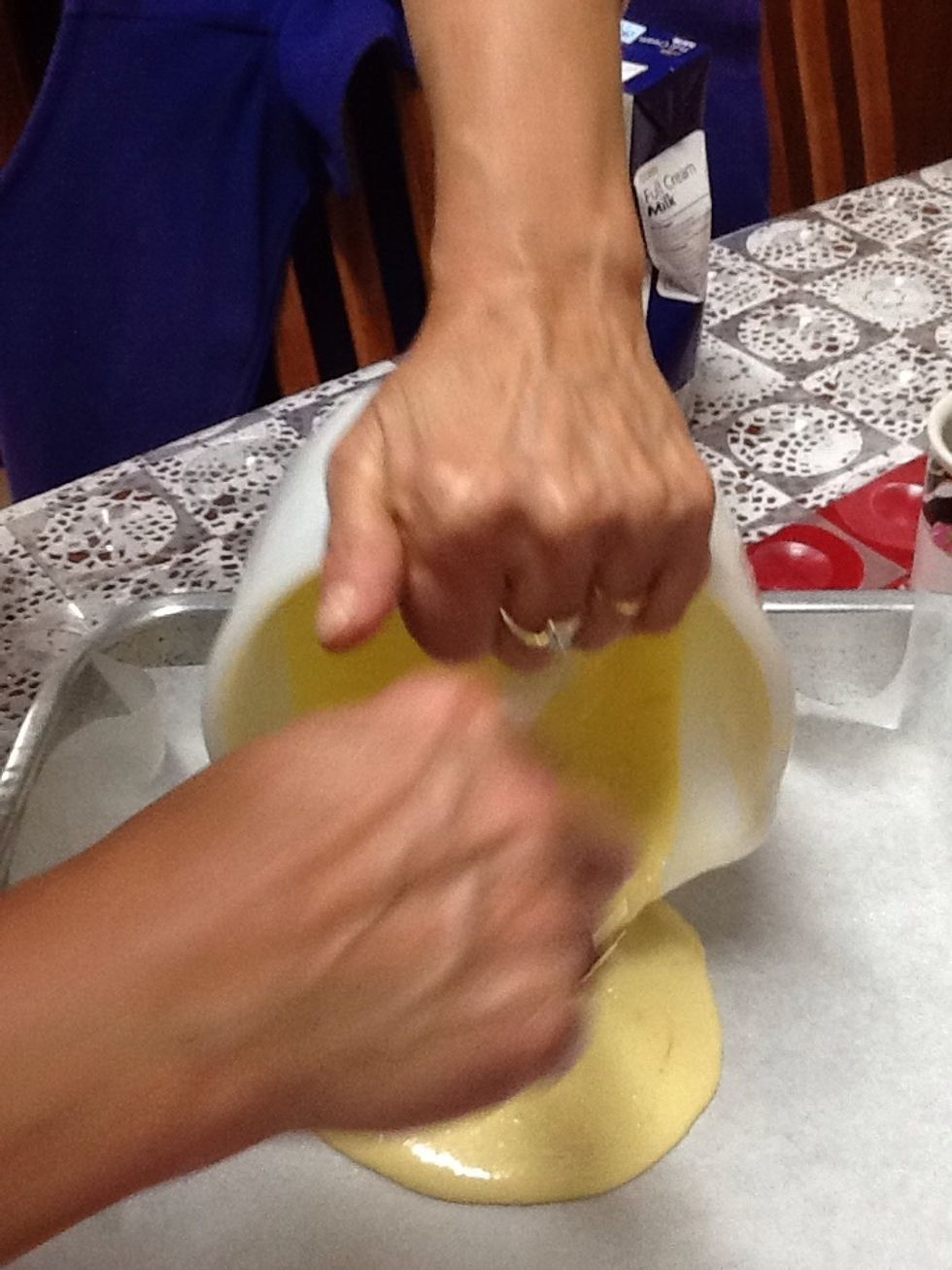 Now you have to pour only half of the batter with the orange zest and the orange juices to the pan.