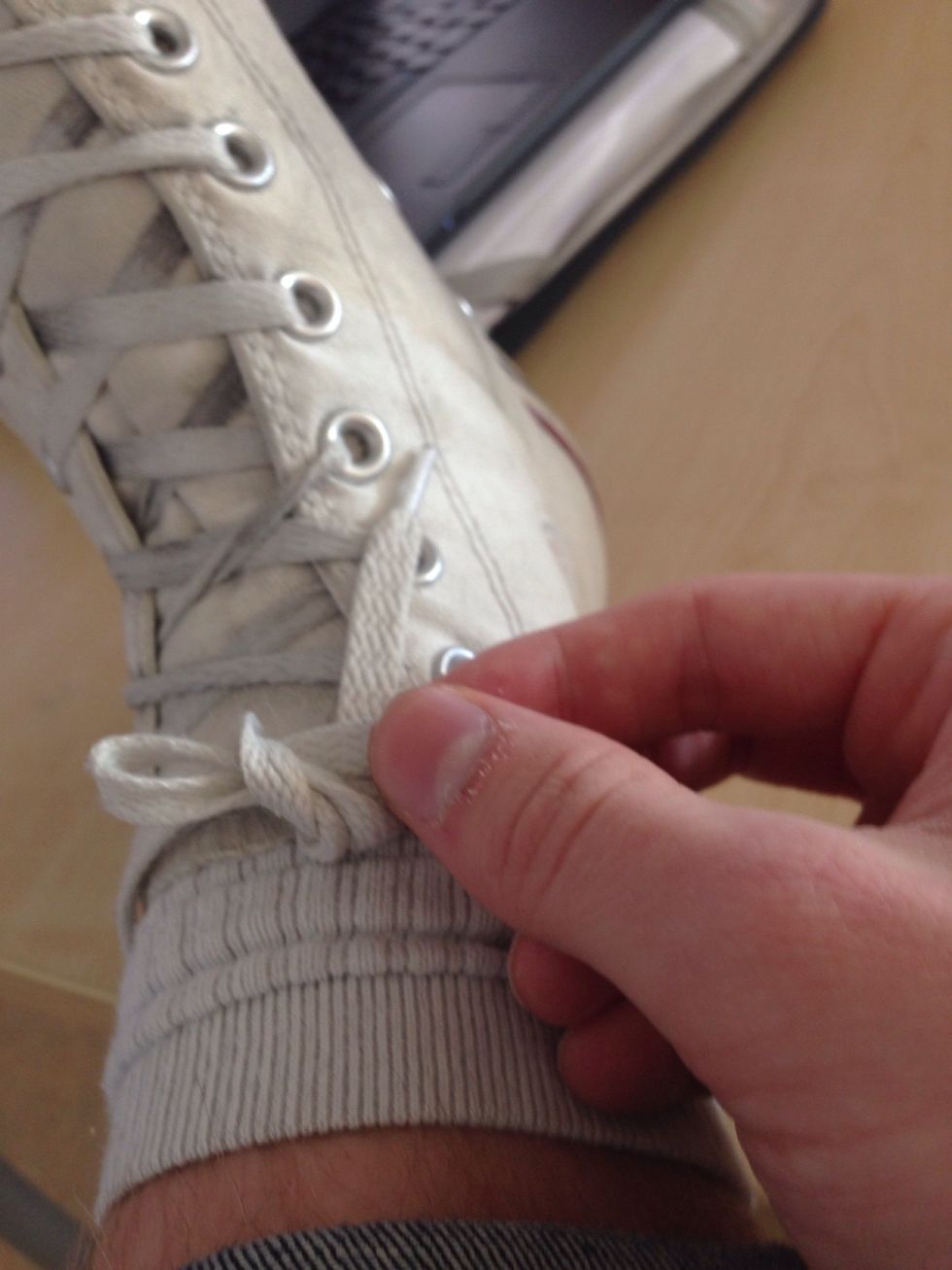 Now you have to take the lace you just wrapped around the other, and put it under itself