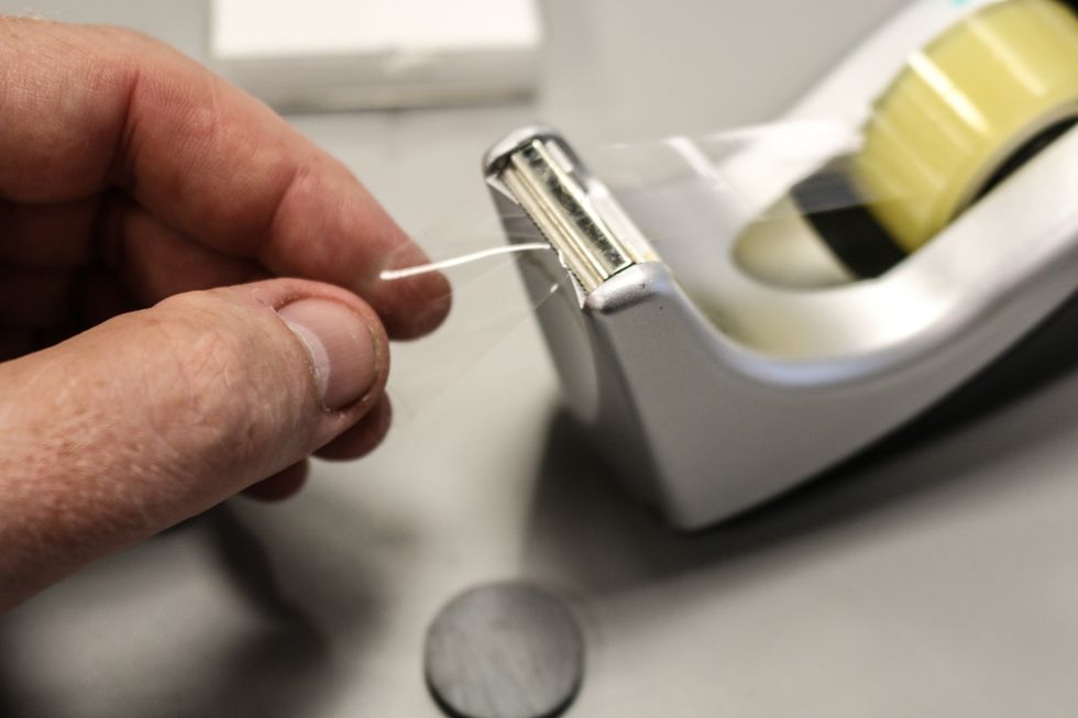 Now you'll be taping down your magnet in place.