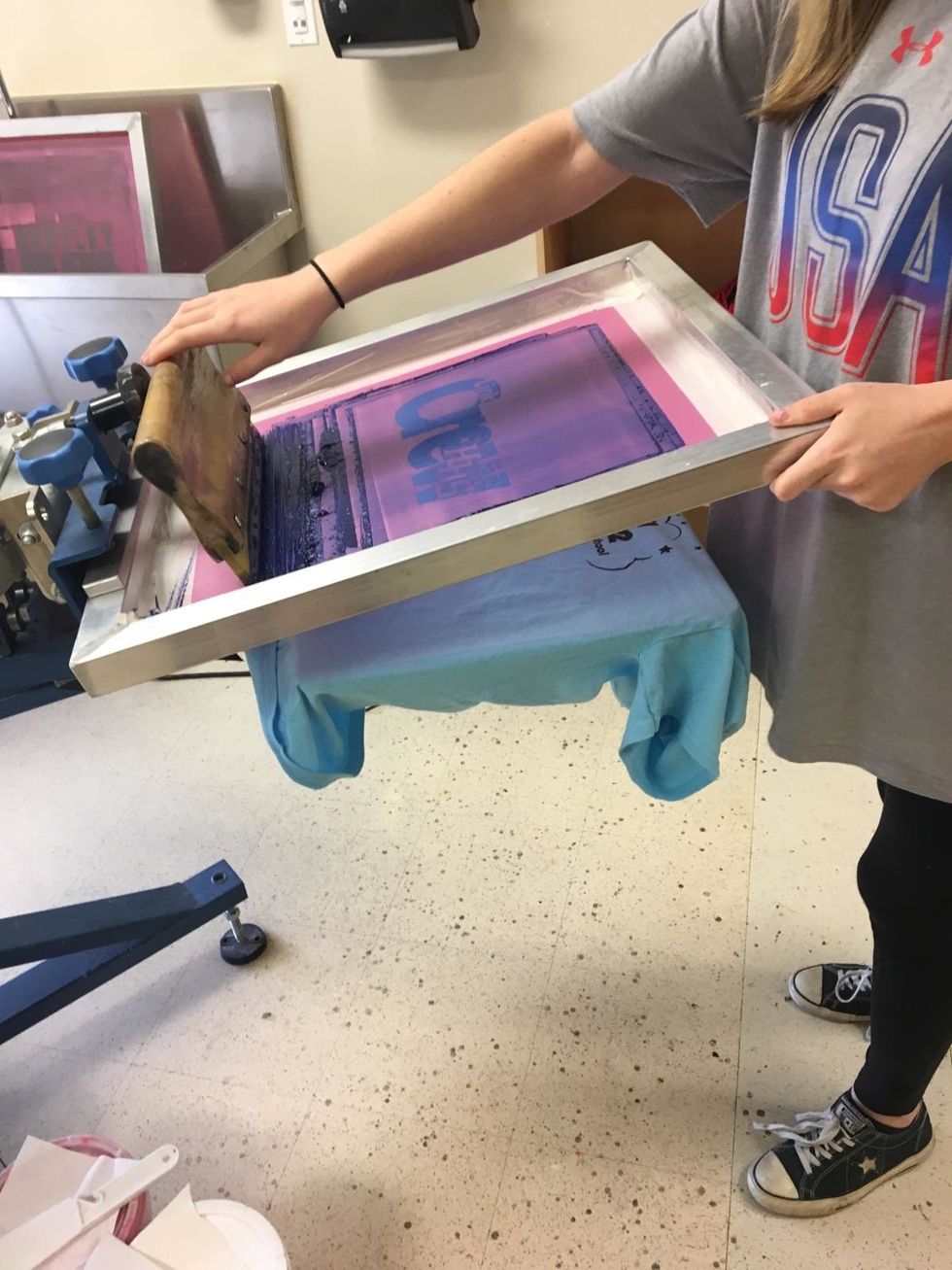 Now you may begin to print on the practice shirt. Make sure to look for holes on the screen. If you see ink in places it shouldn't be, make sure you tape it up on the backside of the screen.