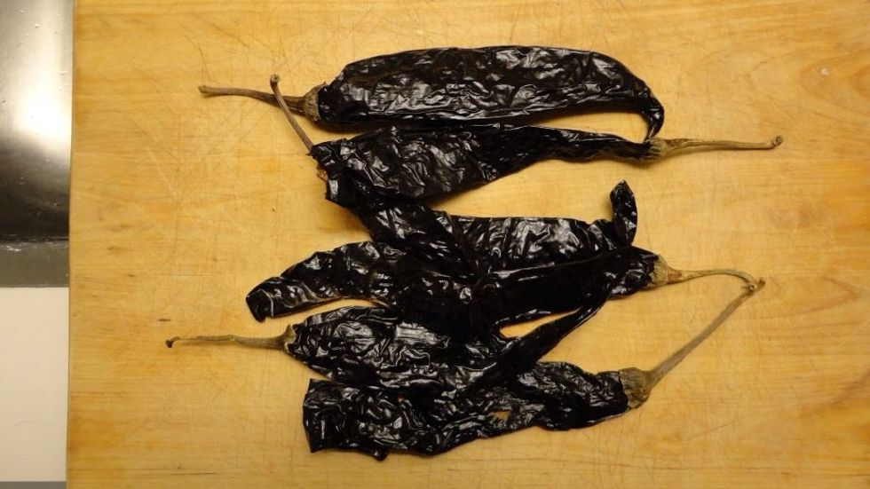 Now, you might have seen dried peppers at the store. Pasilla peppers aren't too spicy and have a delicious smoky aroma. These will also give this salsa its distinctive color.