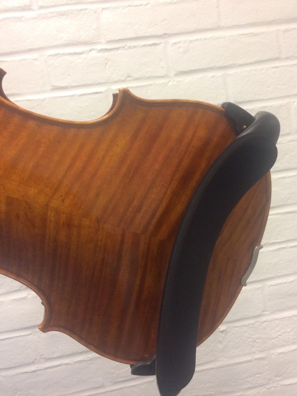 Now you must put the shoulder rest on so it is comfortable to play. Put the rest on by sliding it on the sides of the bottom of the instrument.