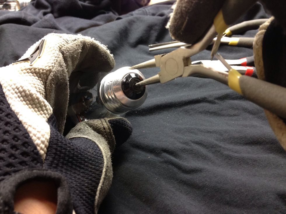 Now you need to break the black glass. To do this, I stuck a tool in the hole and applied pressure. The next step shows the process in a video. NOTE: Be careful as this type of glass tends to fly off.