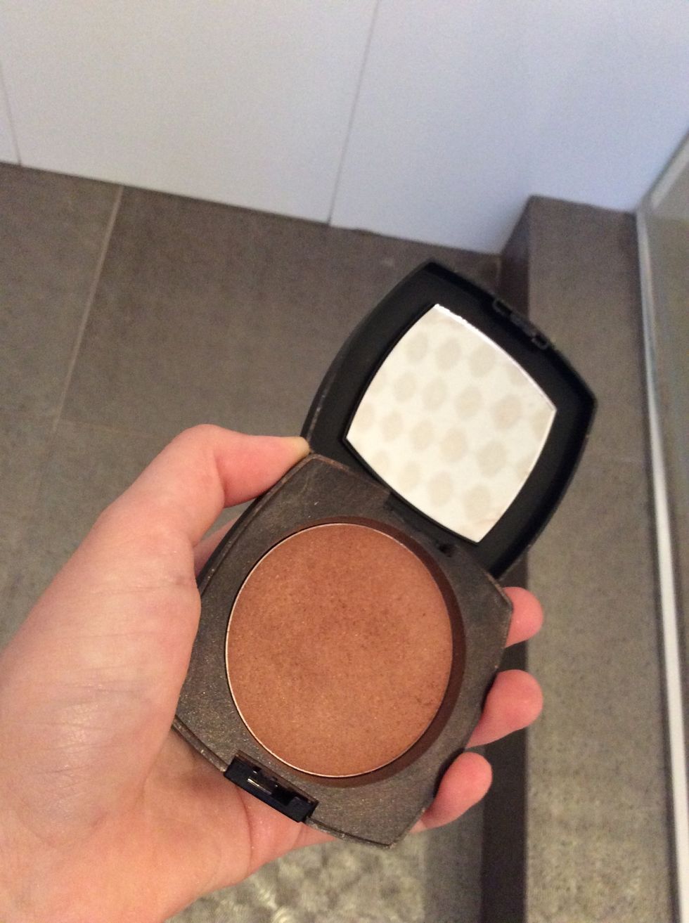 Now you need to contour your cheeks bones, to do that just make the fishy face and then apply the power under your cheek bones.