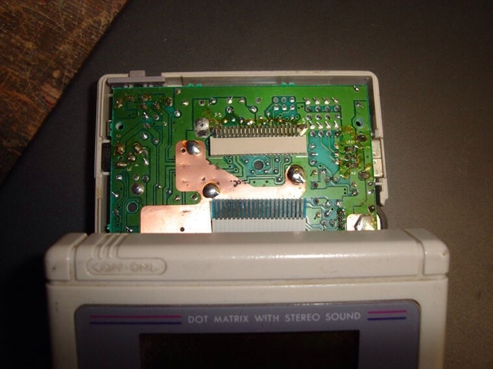 Now you need to disconnect the display cable. BE VERY CAREFUL! The ribbon cable that connects the dot matrix display to the gamboy's motherboard is very thin.