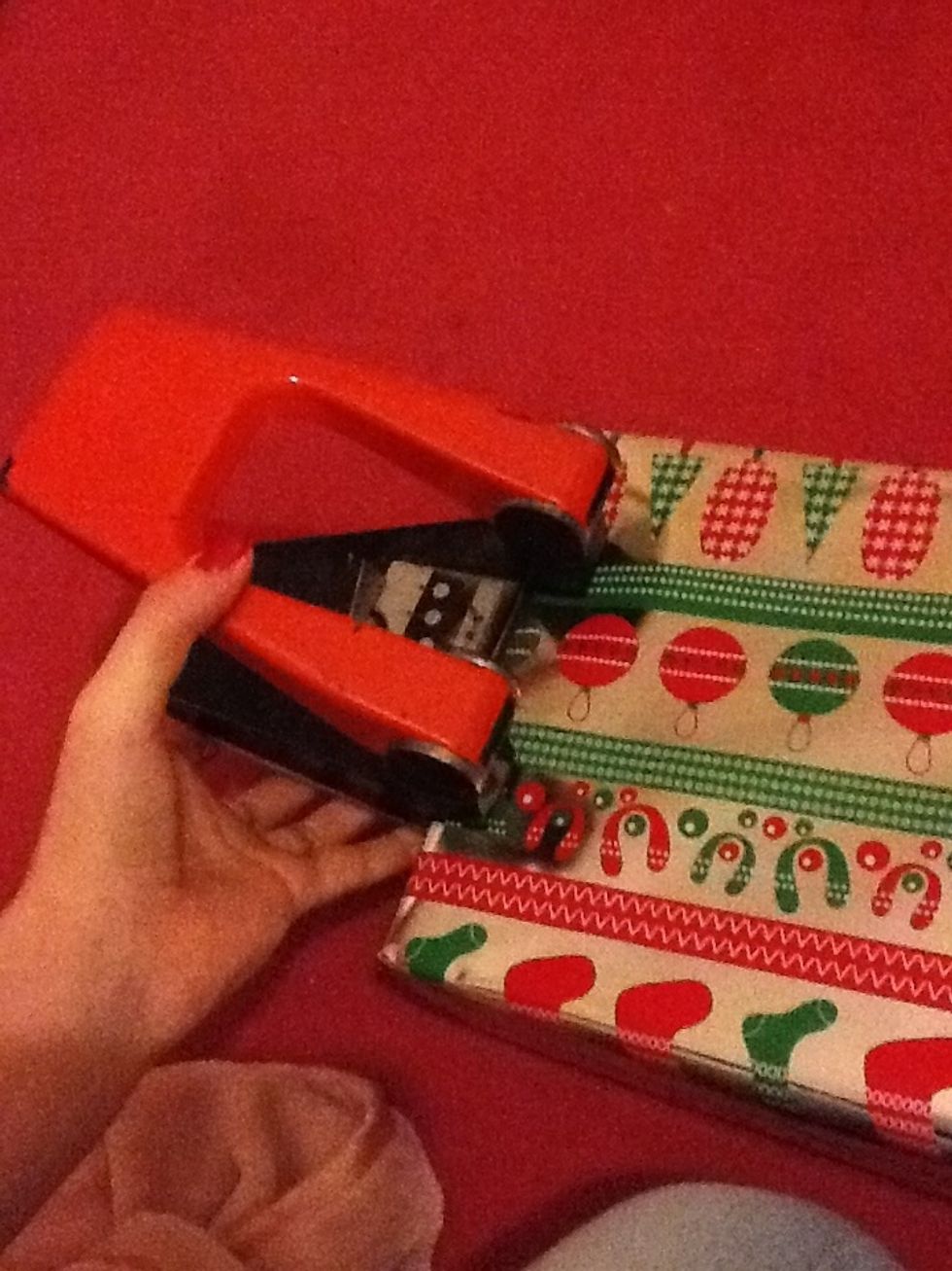 Now you need to hole punch the top of the box on both sides.