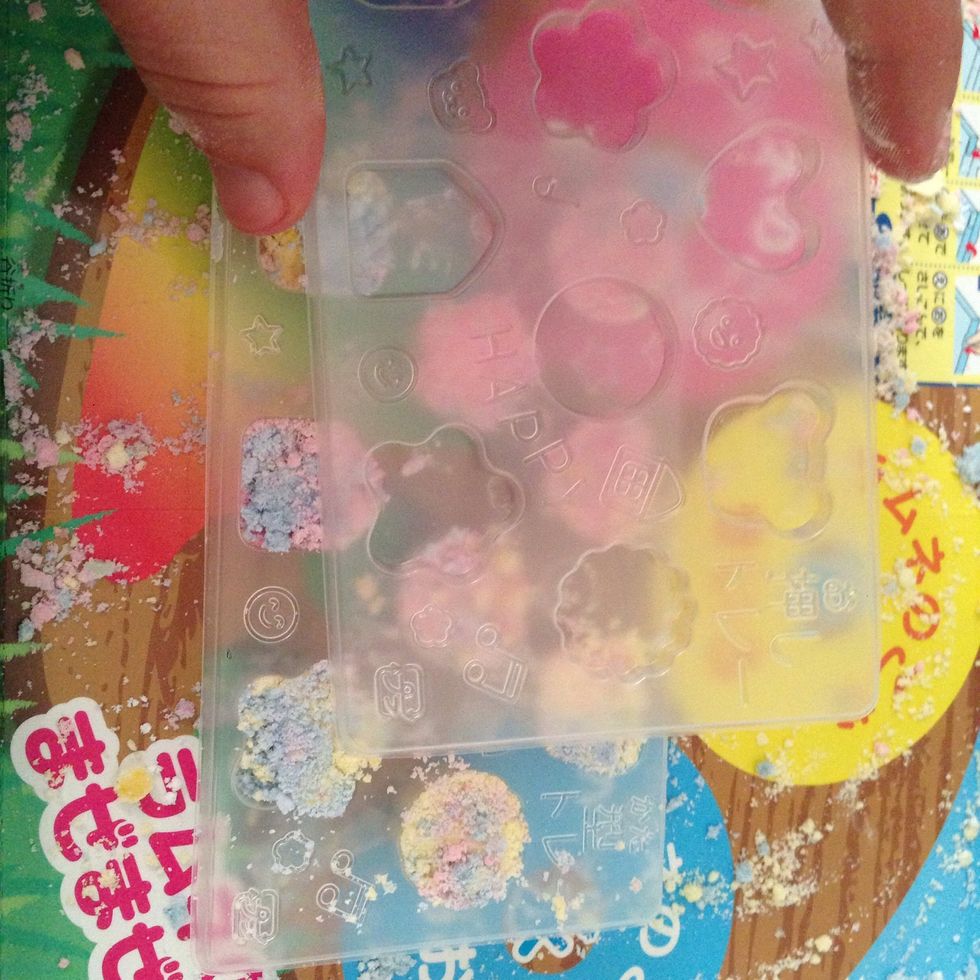 Now you're going to take the top part of the mold which will be used to squeeze it down and impress your designs into your ramune candy tablets