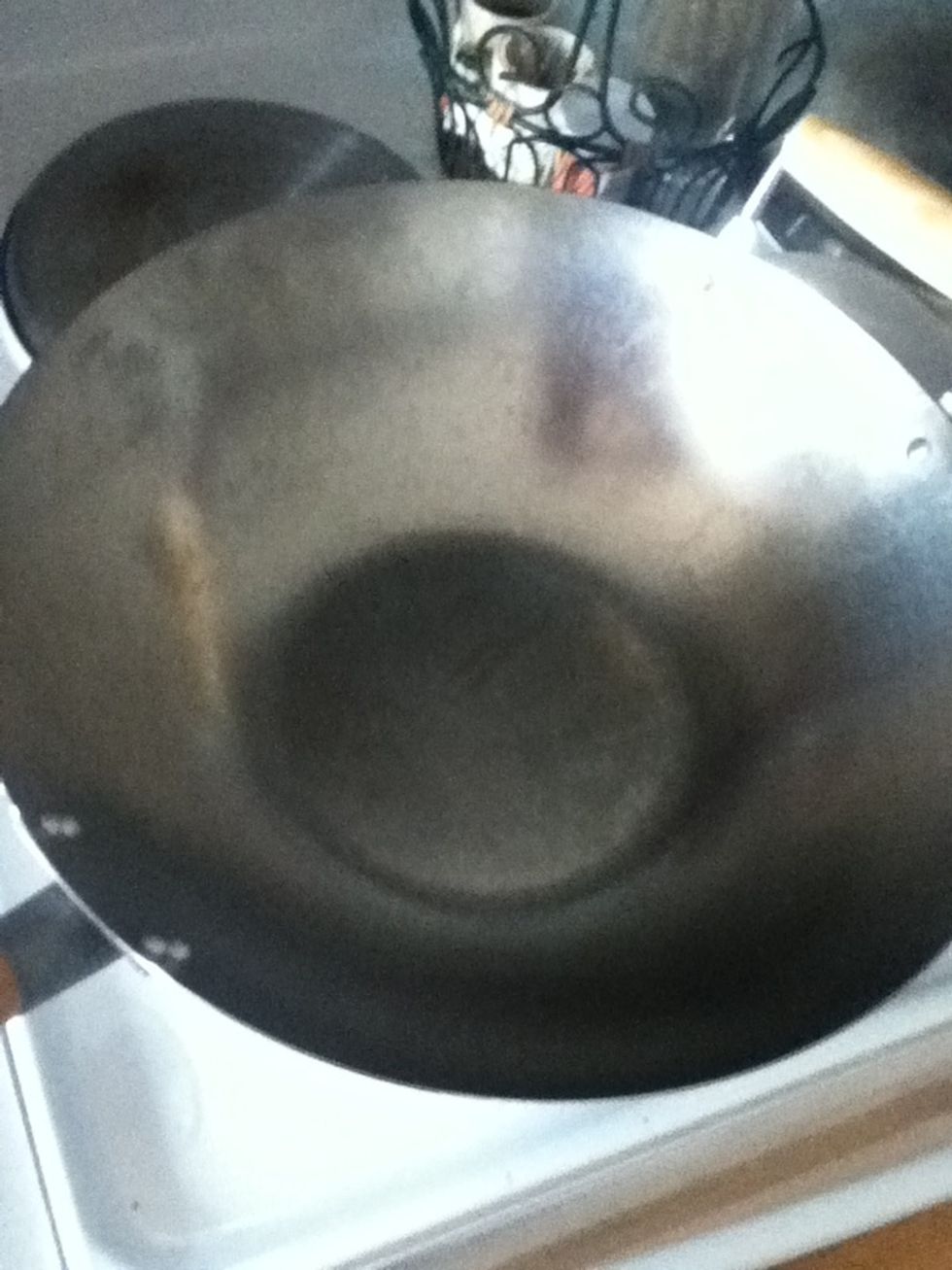Now you're making the rice. This is a technique you might not be familiar with. You're gonna use a wok to fry it so the grains stay separate and it's got a cool nutty taste.