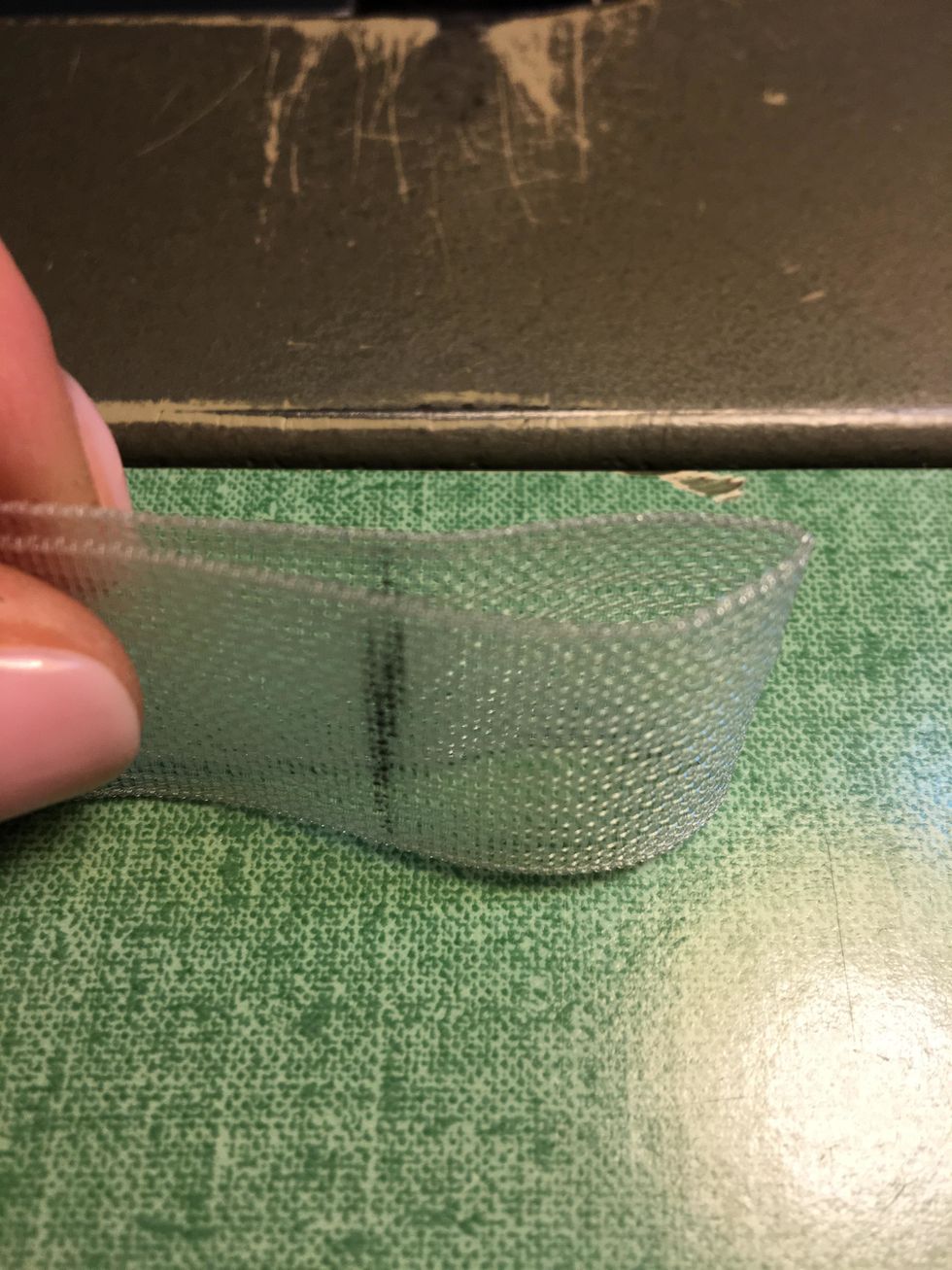 Now you're ready to stitch the magnet pockets. Fold the 2" section of tape so that the two pencil lines meet forming the 1" pocket