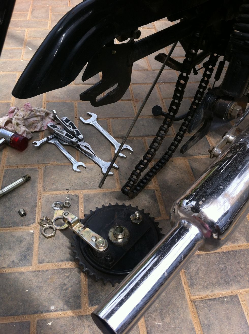 Now you should be able to remove the chain sprocket by carefully nudging it forward and unhooking the chain from the sprocket
