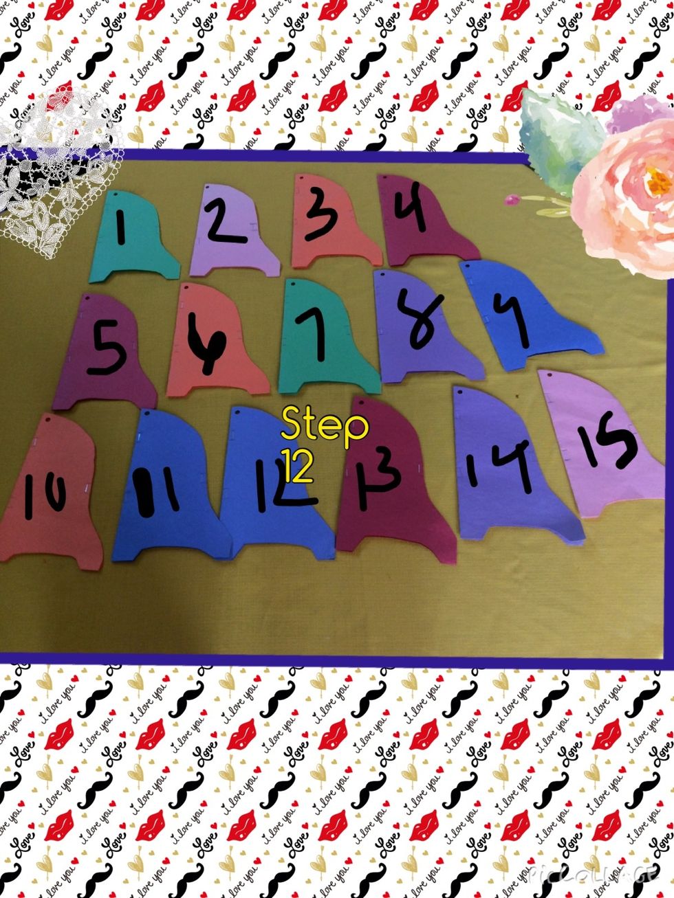 Now you should have 15 construction papers with a hole on top,staples on the sides,and a staple in the middle.