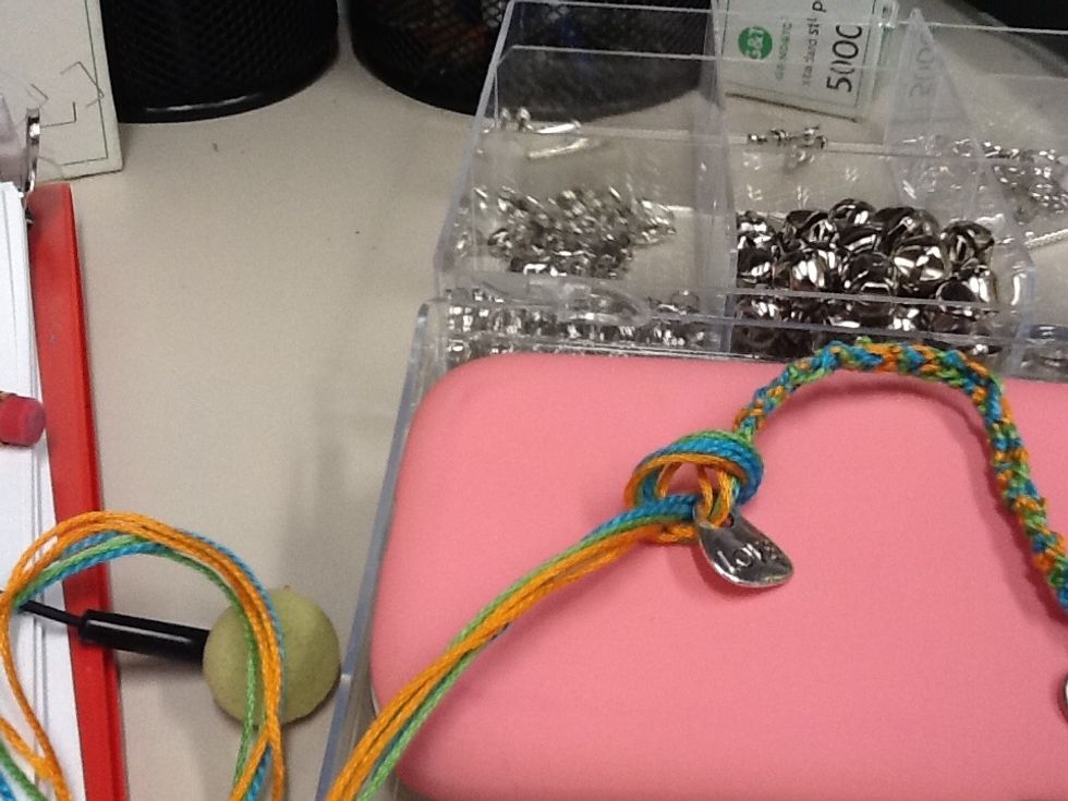 Now you should secure the bracelet and the accessories by tying a knot