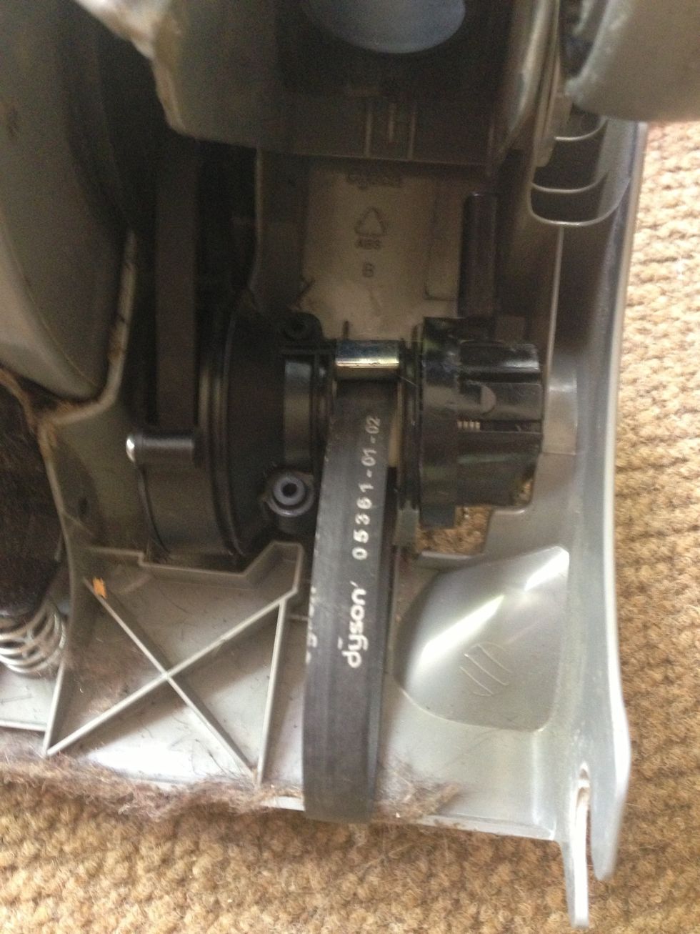 Now you've exposed the clutch. First with a screwdriver slide the main belt off the motor shaft. . Then to remove the clutch it is grab both belts, one in each hand, and pull