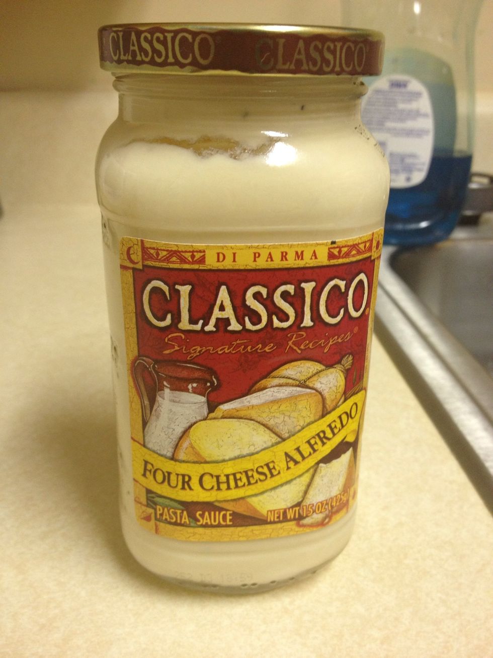 Now, you will add the alfredo sauce. I only used one jar since I only used half a box of noodles. If you use more noodles then you may want to use 1/2 to 2 jars of the alfredo sauce.