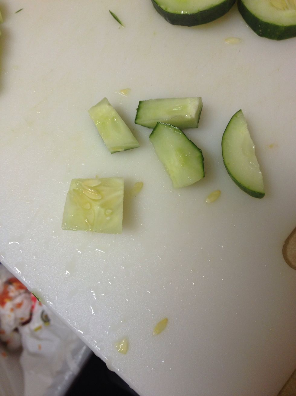 Now you will cut up the cucumber. As you can see I cut around the middle part and discard of it. I only use the edges of the cucumber because the middle of it is too soft and full of seeds.