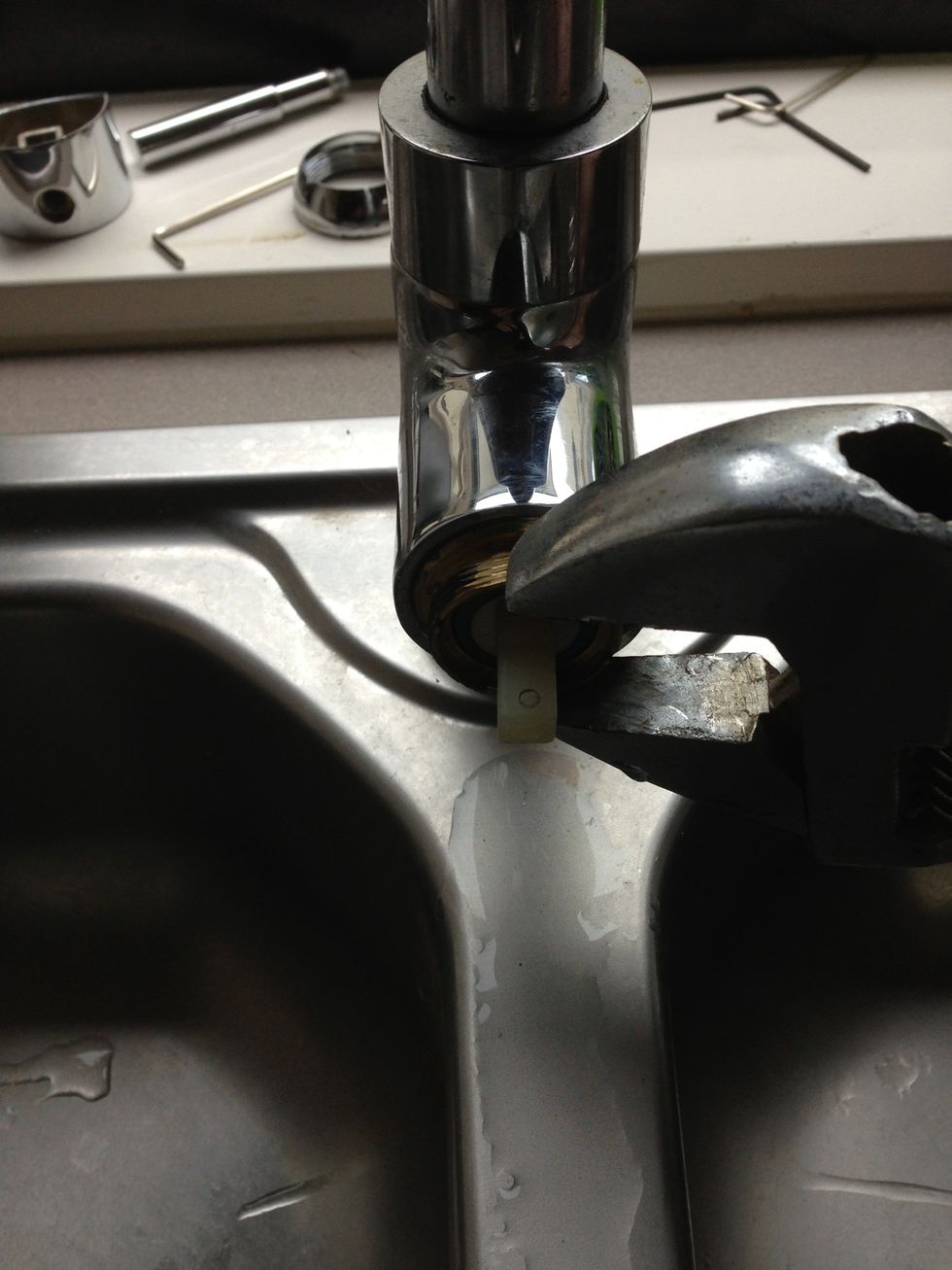Now you will have a brass fitting that keeps the cartridge in place, you will need your adjustable wrench or shifter to undo. Look for the flat edges to line up and turn anti clockwise
