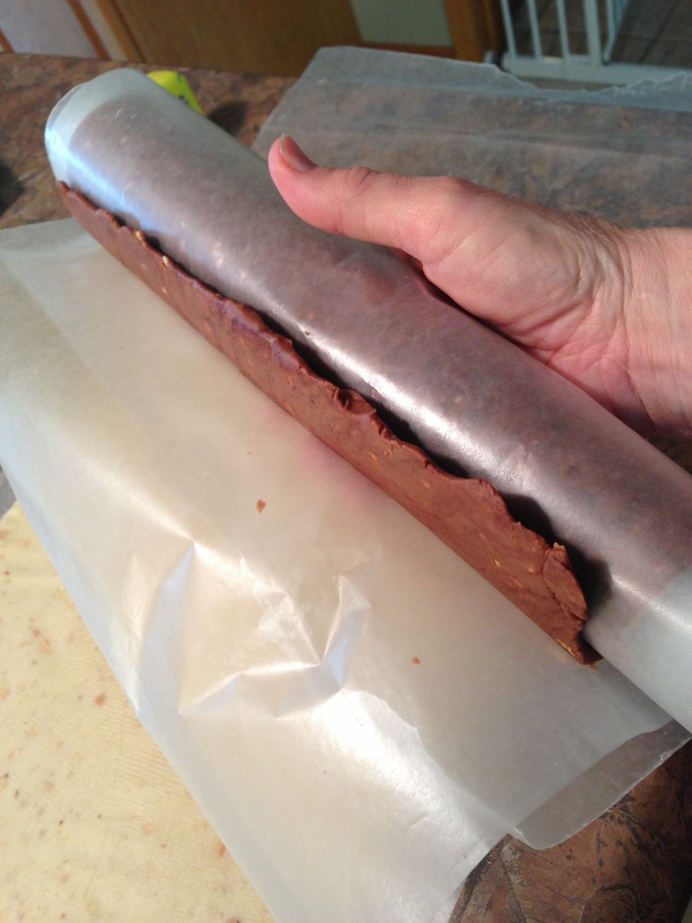 Now you will truly see the value of the wax paper! Unroll wax paper from edge of chocolate just enough to expose about 1 inch and move over to just above white dough edge.