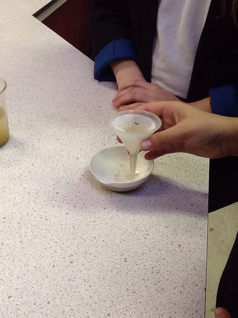 Now your funnel is a filter. Hold you filter over your bowl until all the clean water comes out.